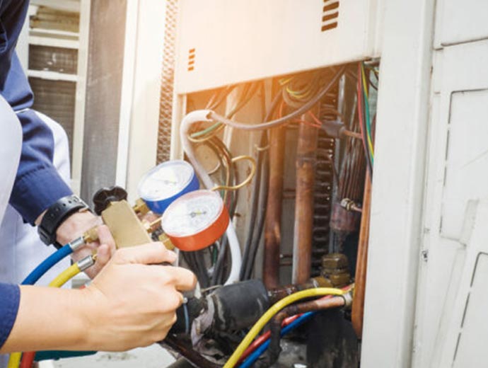 Man crossing wires in an AC Installation in Durham